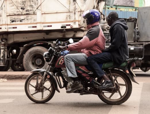 Riders with electric two- and three-wheelers at a Chaji site